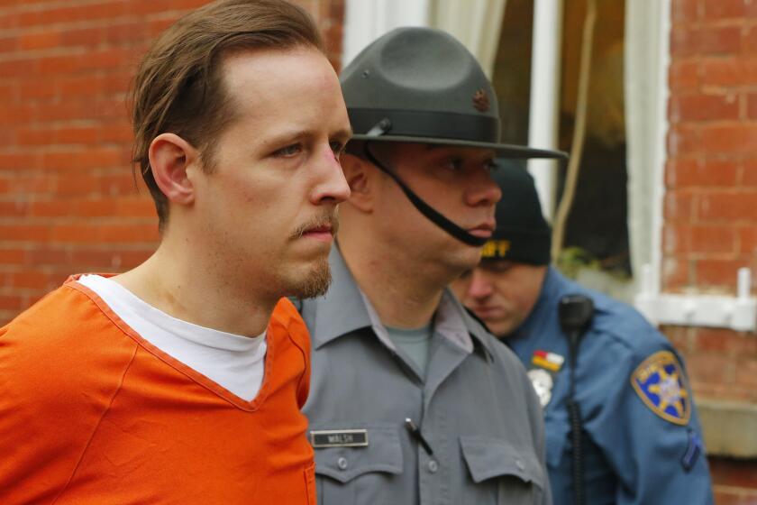 Eric Frein is escorted by police out of the Pike County Courthouse after his arraignment in Milford, Pa. Frei, was captured seven weeks after police say he killed a Pennsylvania state trooper in an ambush outside a barracks in northeastern Pennsylvania.