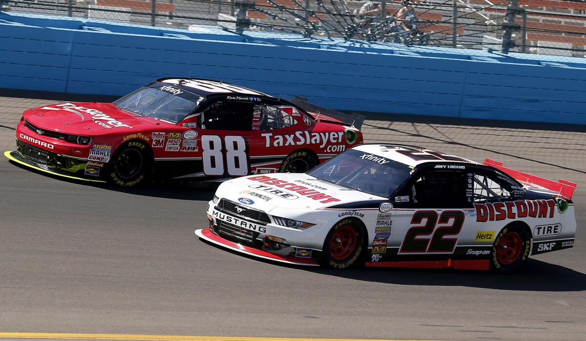 Joey Logano (22) and Kevin Harvick battle for the lead during the NASCAR Xfinity Series race on Saturday.