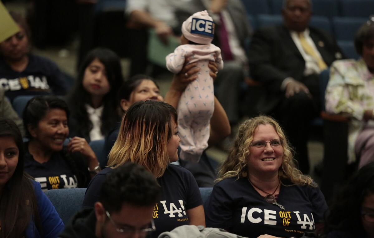 Immigration agents will be allowed back into Los Angeles County jails to identify deportable inmates under a policy made public Tuesday by Sheriff Jim McDonnell. Above, people attend a Board of Supervisors meeting in May when a previous policy allowing such cooperation was ended.