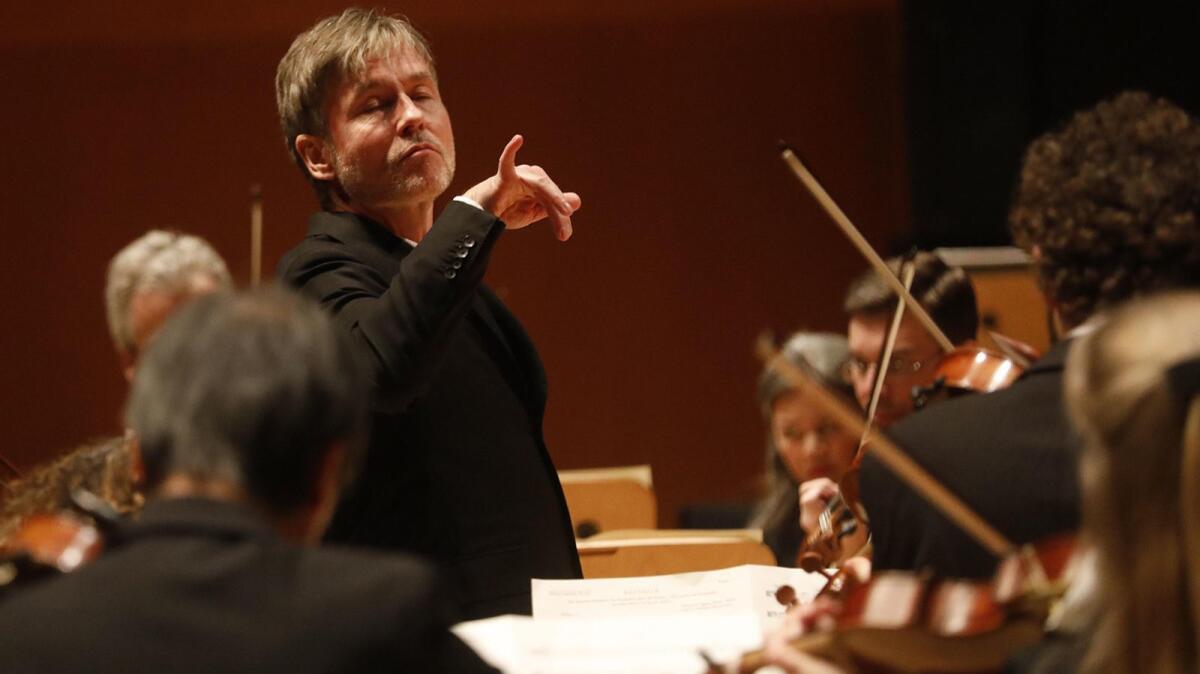 Esa-Pekka Salonen conducting the L.A. Philharmonic, with eyes closed and pinkie extended.