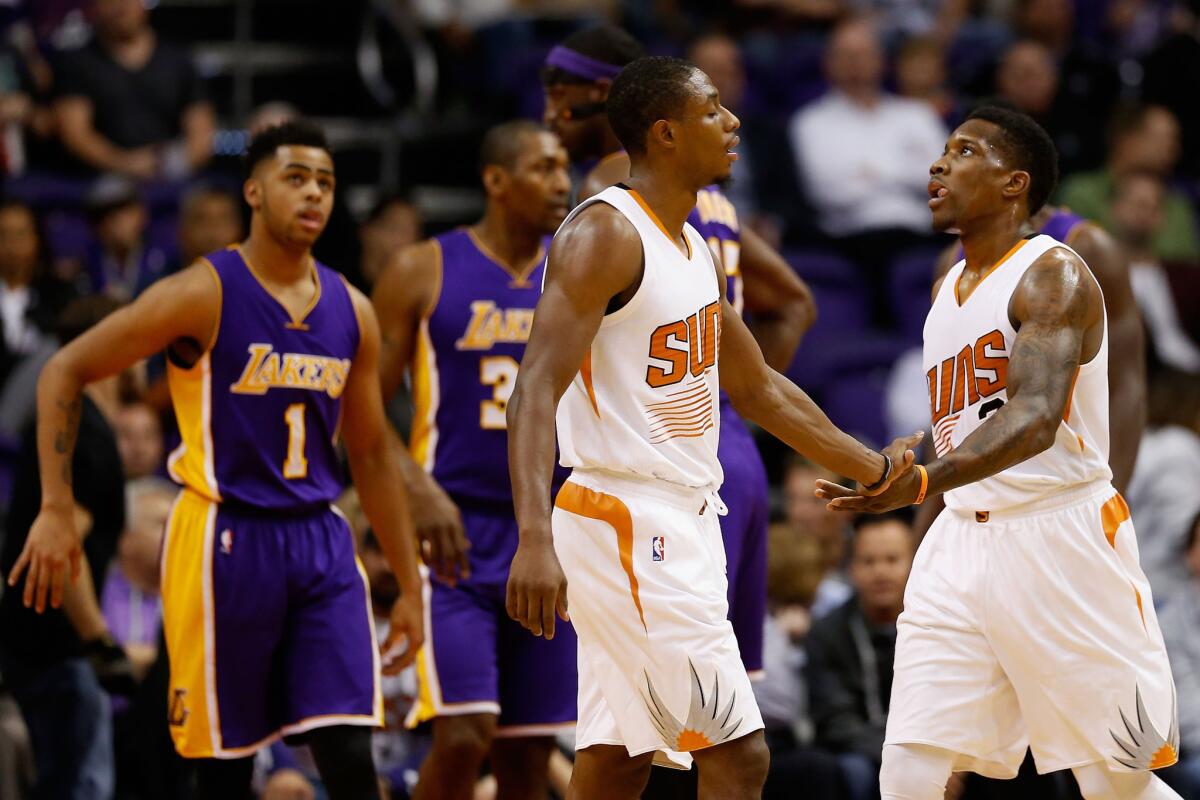 Suns guard Eric Bledsoe celebrates with teammate Brandon Knight after scoring against the Lakers during a Nov. 16 game in Phoenix.