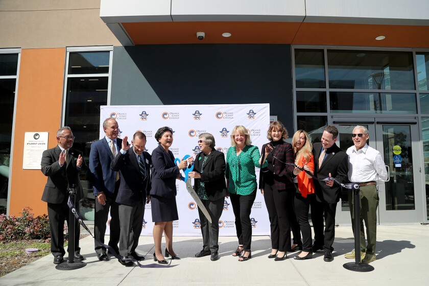 Officials gather to cut the ceremonial ribbon during a dedication event for OCC's student union on Thursday.