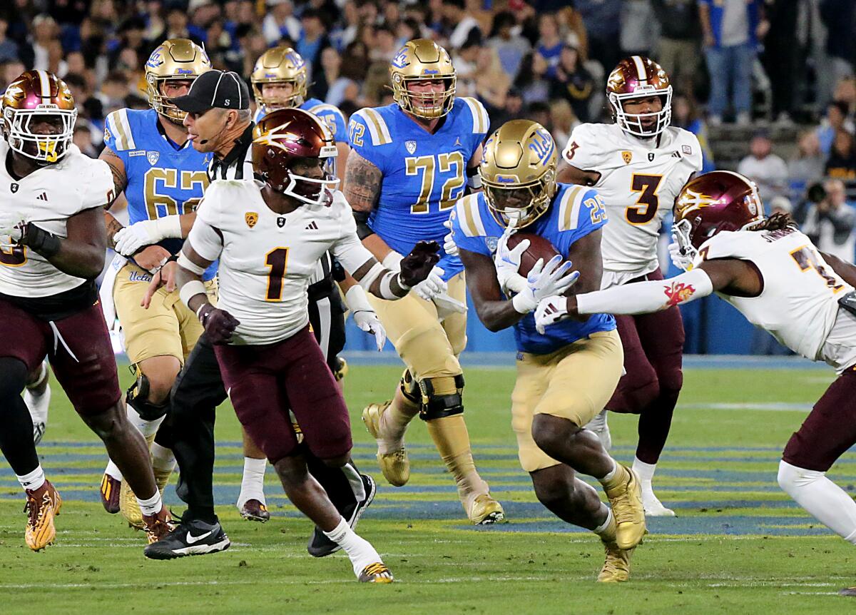 UCLA running back T.J. Harden breaks into the Arizona State secondary in the first quarter.