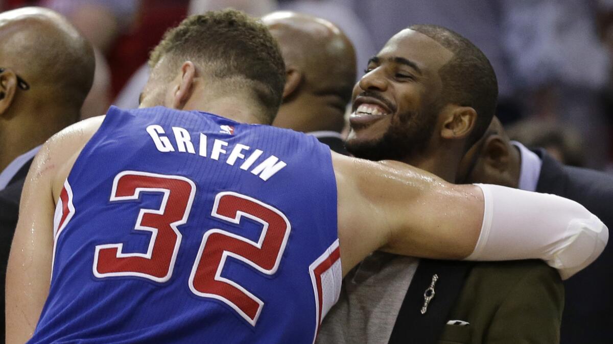 Clippers forward Blake Griffin, left, hugs teammate Chris Paul after the Clippers' 117-101 victory over the Houston Rockets in Game 1 of the Western Conference semifinals on May 4, 2015.