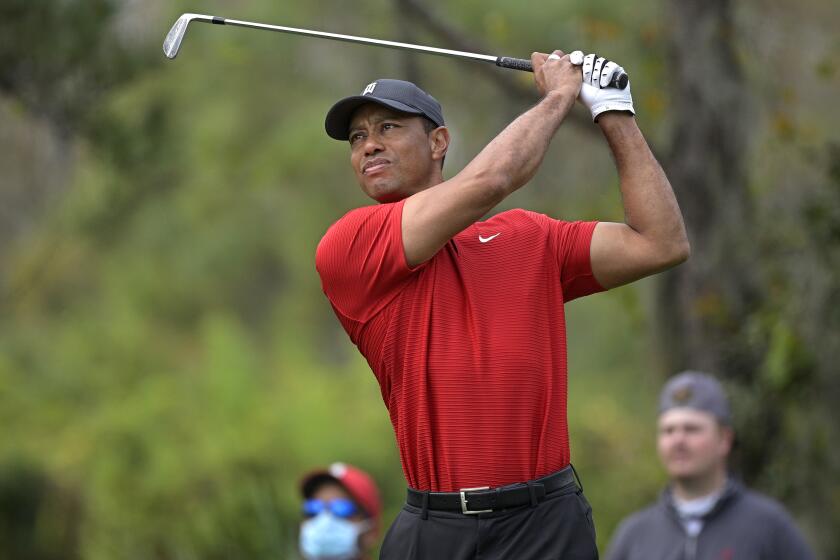 FILE - Tiger Woods watches his tee shot on the fourth hole during the final round of the PNC Championship golf tournament in Orlando, Fla., on Dec. 20, 2020. "Tiger," a two part documentary about Woods premieres Jan. 10 on HBO. (AP Photo/Phelan M. Ebenhack, File)
