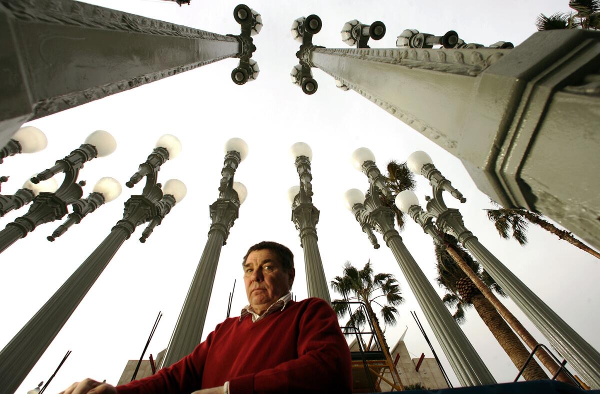 Chris Burden created "Urban Light," a sculpture in front of the entryway to the Los Angeles County Museum of Art that consists of genuine street lamps from Los Angeles' past. He is pictured with the piece in 2008.