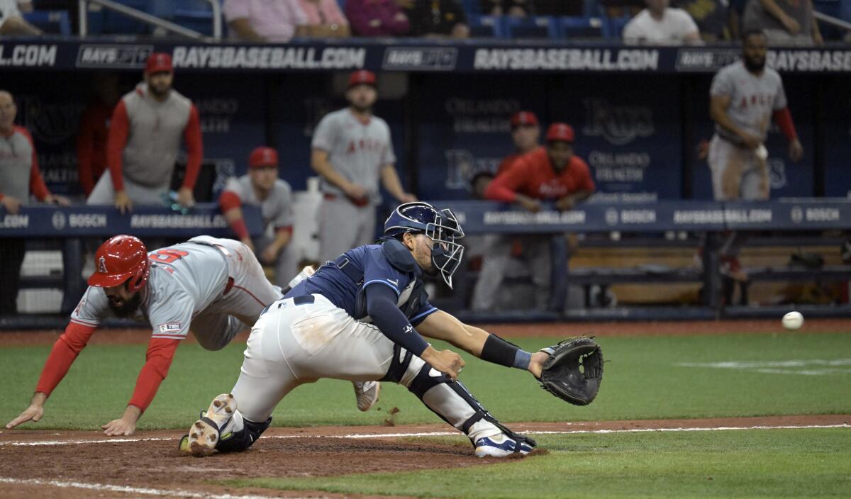 Anthony Rendon beats the throw to Rays catcher Rene Pinto to score the go-ahead run in the ninth inning.
