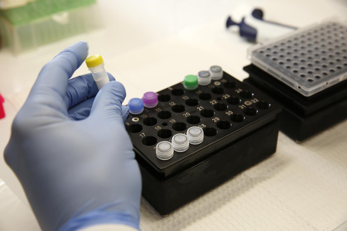 Brian Bowland, senior clinical lab specialist in microbiology in the UCLA Health System, prepares a master mix for testing of the COVID-19 coronavirus.