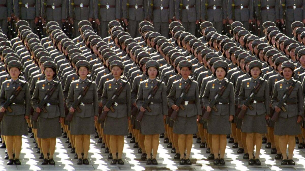North Korean women soldiers toting rifles stand at attention during a massive military parade in Pyongyang in 2002.