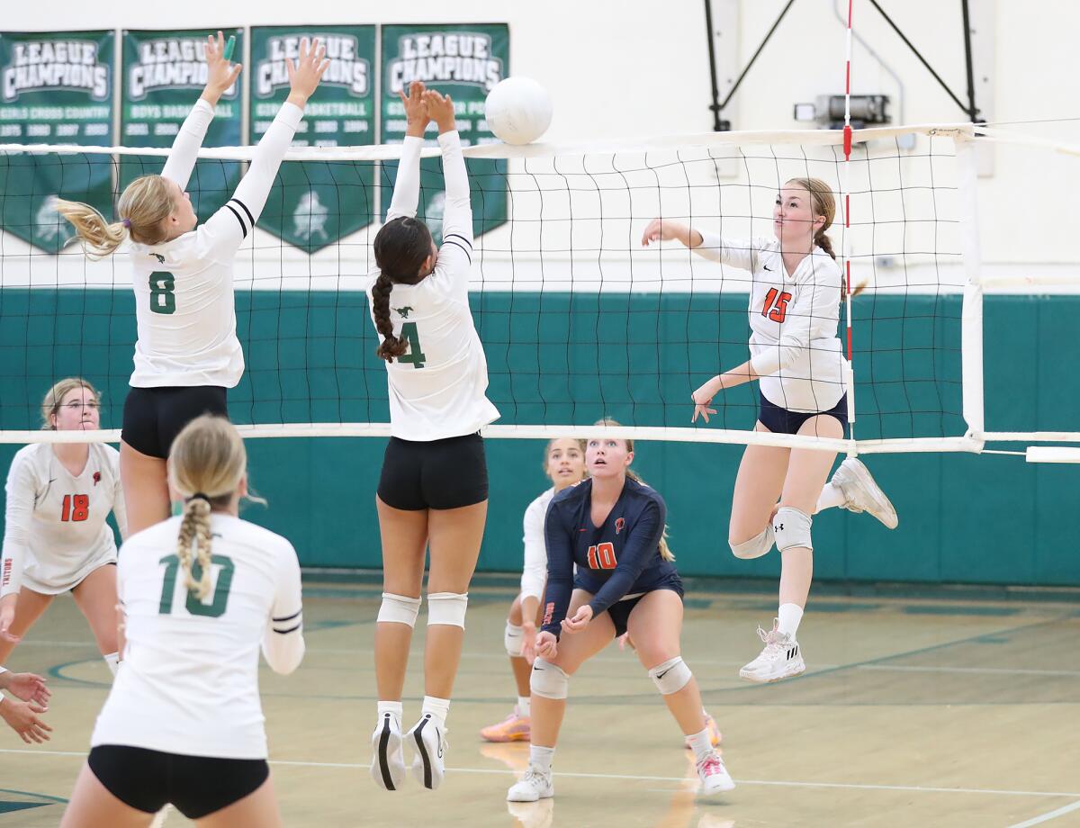Pacifica Christian's Emma Hartman (15) puts a kill past Lucca Miller (8) and Emi Kamikihara (4) of Costa Mesa on Thursday.