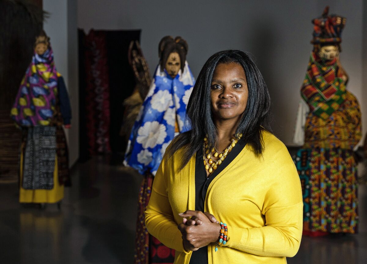 Denise Rogers, a professor of art history, poses at the “Africa in Context” exhibit at San Diego Mesa College 