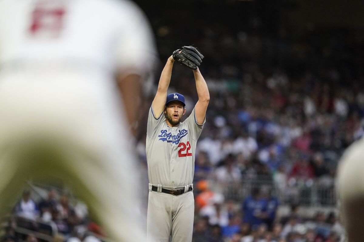 Dodgers starter Clayton Kershaw stretches while delivering a pitch during the third inning Saturday.