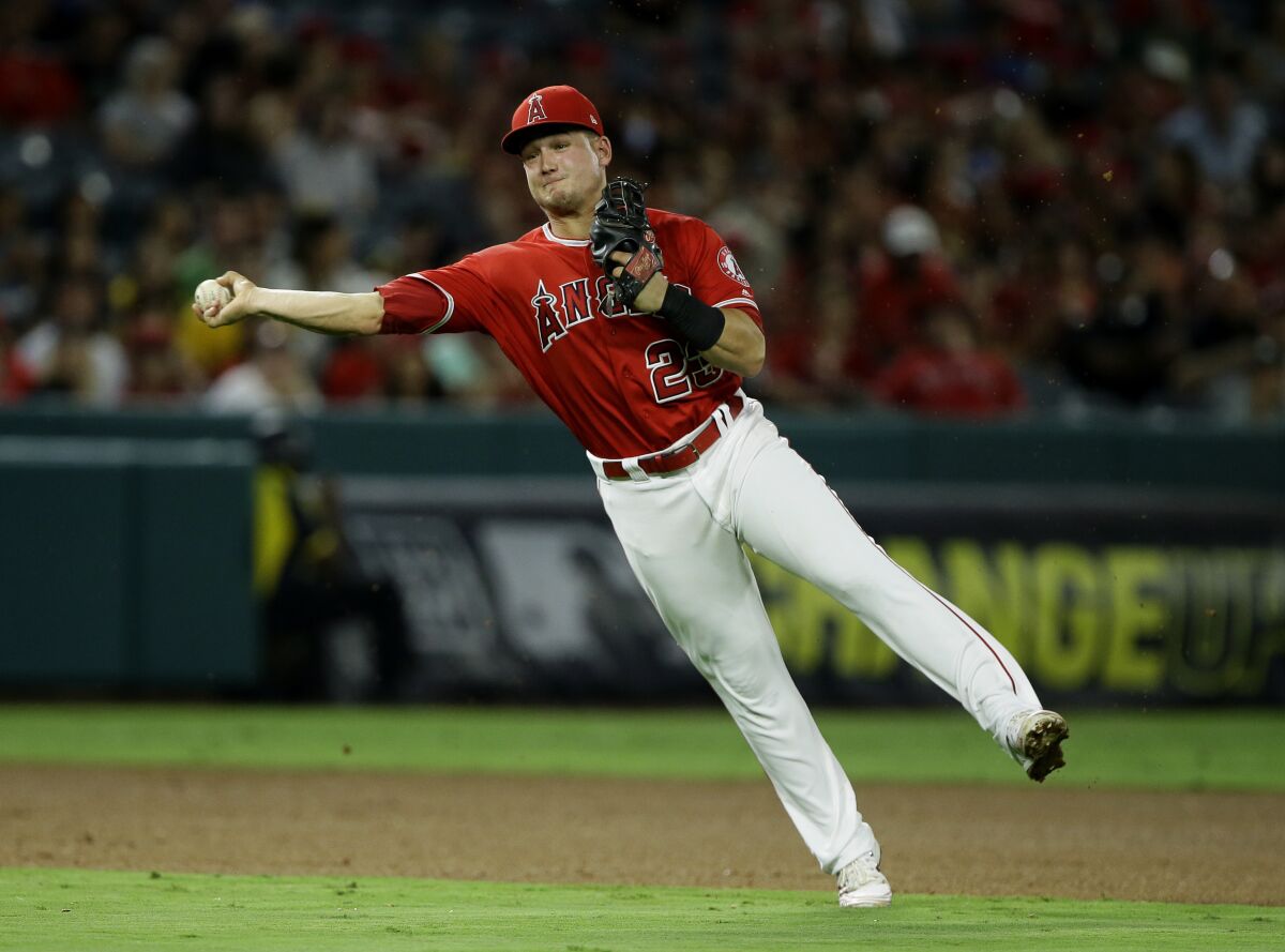 The Angels' Matt Thaiss attempts to throw out Oakland Athletics' Ramon Laureano.