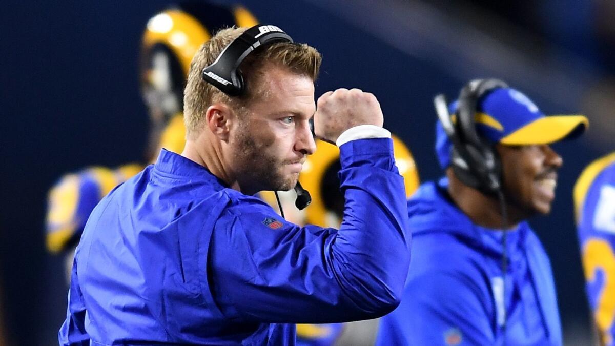 Rams head coach Sean McVay celebrates a touchdown by running back Todd Gurley against the Cowboys at the Coliseum on Jan. 12, 2019.