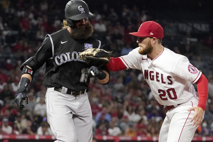 Colorado Rockies' Charlie Blackmon is tagged out by Angels first baseman Jared Walsh.