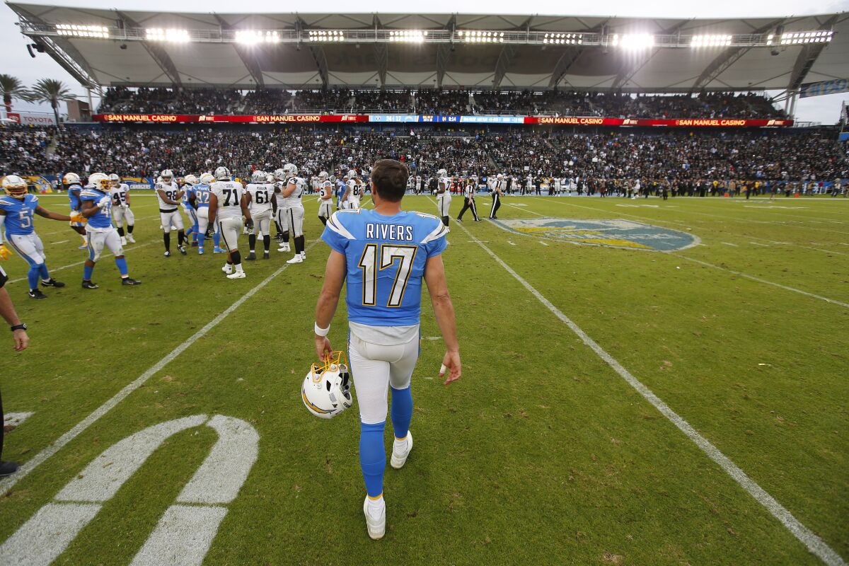 Chargers quarterback Philip Rivers walks off the field after a 24-17 loss to the Oakland Raiders on Sunday.