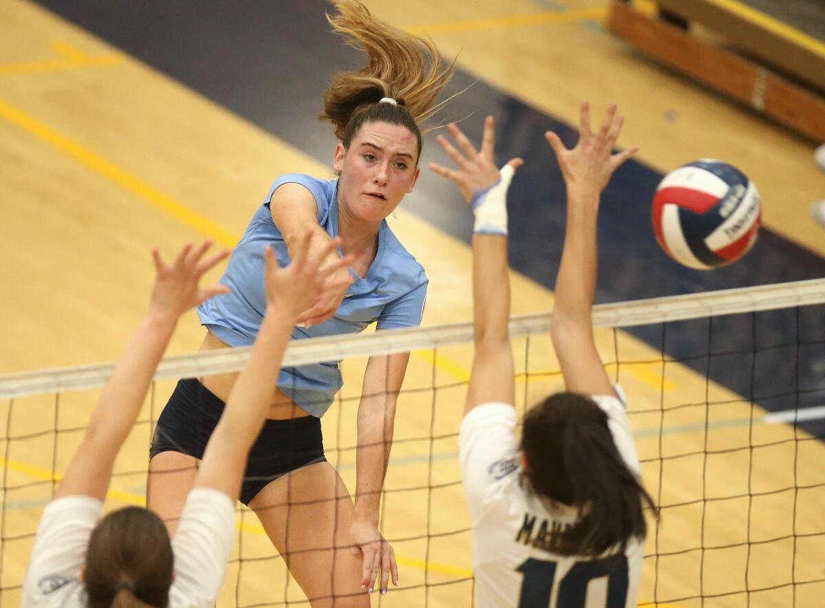 Corona del Mar's Molly Joyce, center, puts the ball away for a point past two La Costa Canyon blockers in the quarterfinals of the CIF State Southern California Regional Division I playoffs on Nov. 14 in Carlsbad.