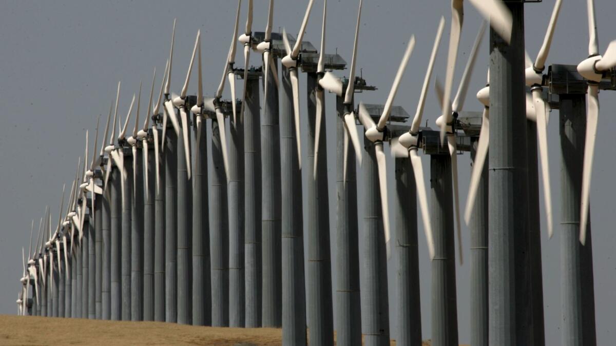 Rows of wind turbines are seen at the Altamont Pass wind farm in Byron, Calif. The House tax bill proposed cutting a tax credit used by the wind-power industry, but a compromise bill keeps the current credit in place.