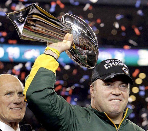 Green Bay Coach Mike McCarthy holds the Lombardi Trophy aloft after the Packers defeated the Pittsburgh Steelers, 31-25, in Super Bowl XLV on Sunday at Cowboys Stadium.