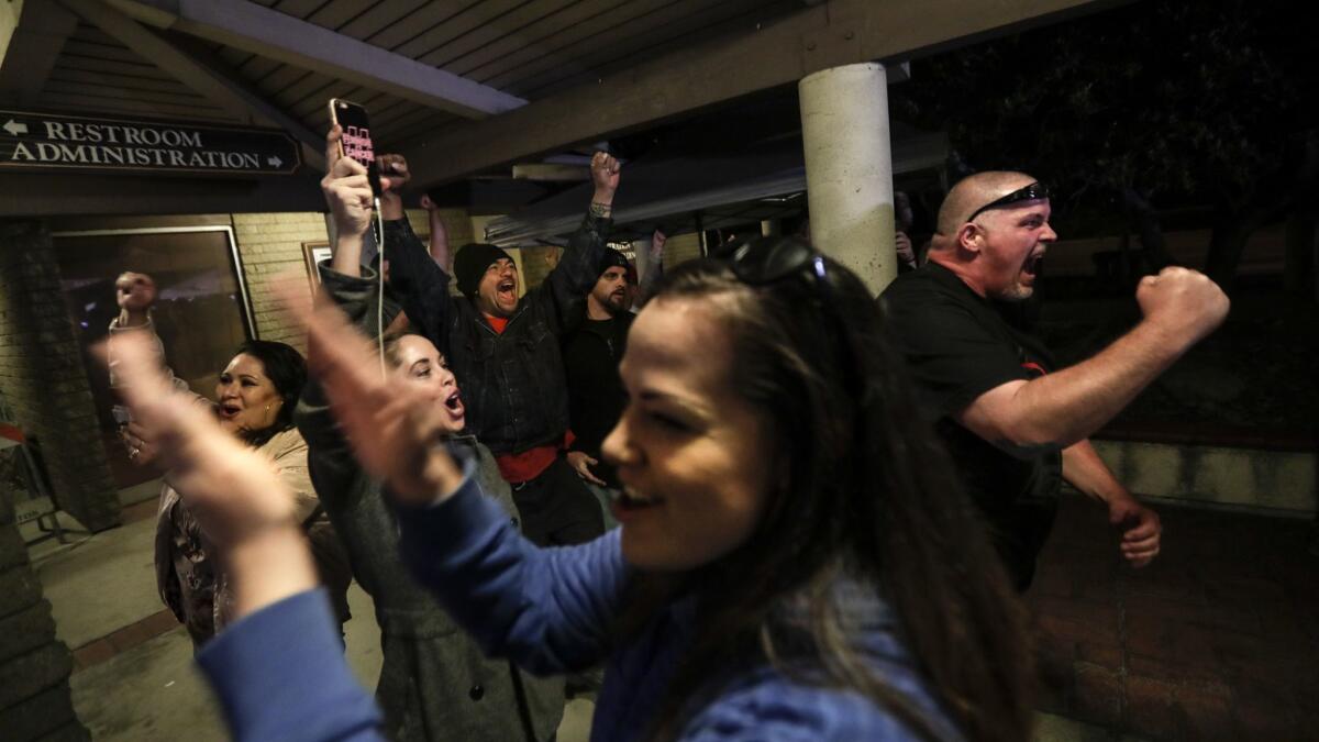 Spectators cheer as the Los Alamitos City Council votes to oppose California's sanctuary state law.