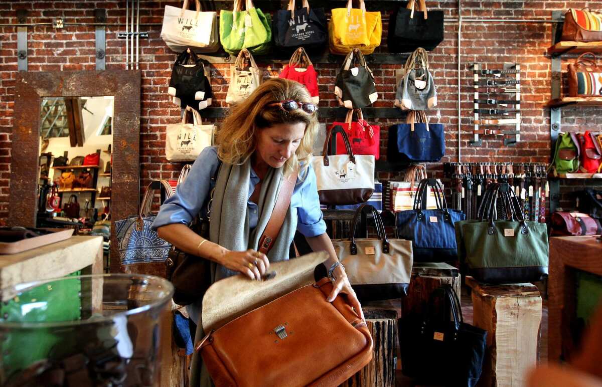 Katerina Tana shops for a bag at the flagship store of Will Leather Goods in Venice