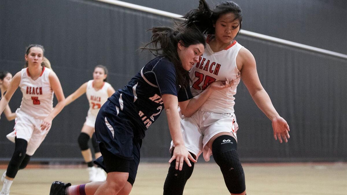 Huntington Beach's Marisa Tanga guards Newport Harbor's Lexi Alvarez, while Alyssa Real, left, runs back on defense in a Sunset League game on Jan. 4, 2018.