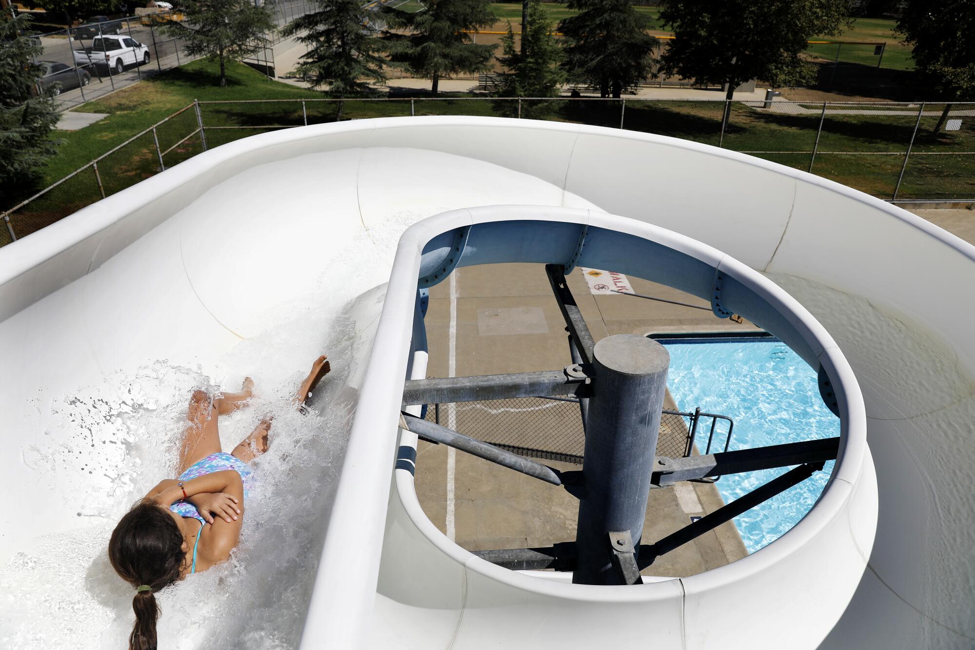 A child goes down the water slide at the Hubert H. Humphrey Recreation Center in Pacoima on Aug. 2.