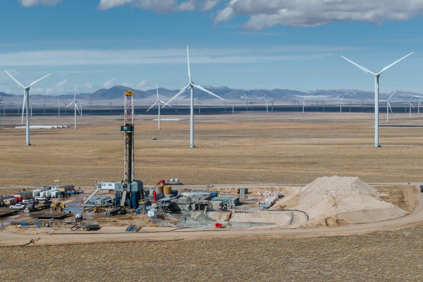 A drilling rig at the Cape Station geothermal project, currently under construction in Beaver County, Utah. In the background is the Milford wind farm, which supplies electricity to Los Angeles.
