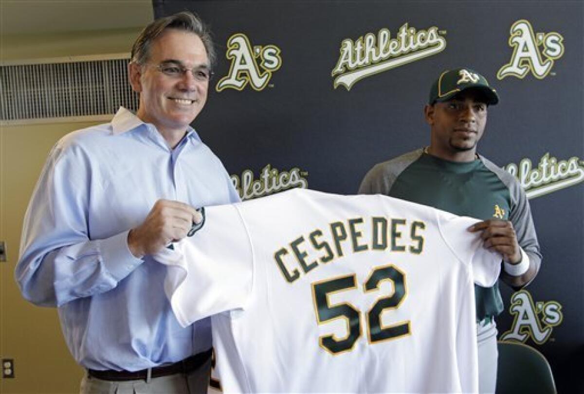 Oakland Athletics' General Manager Billy Beane stands with former