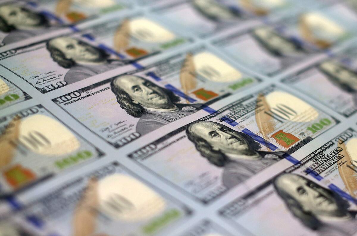 The U.S. Labor Department may extend fiduciary duty standards to paid IRA advisors. Above, newly printed $100 notes at the Bureau of Engraving and Printing in Washington.