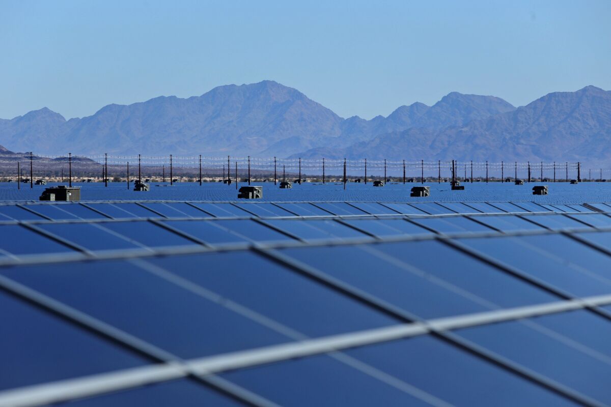 Photovoltaic solar cells soak in the afternoon sun at a solar farm in Riverside County, Calif.