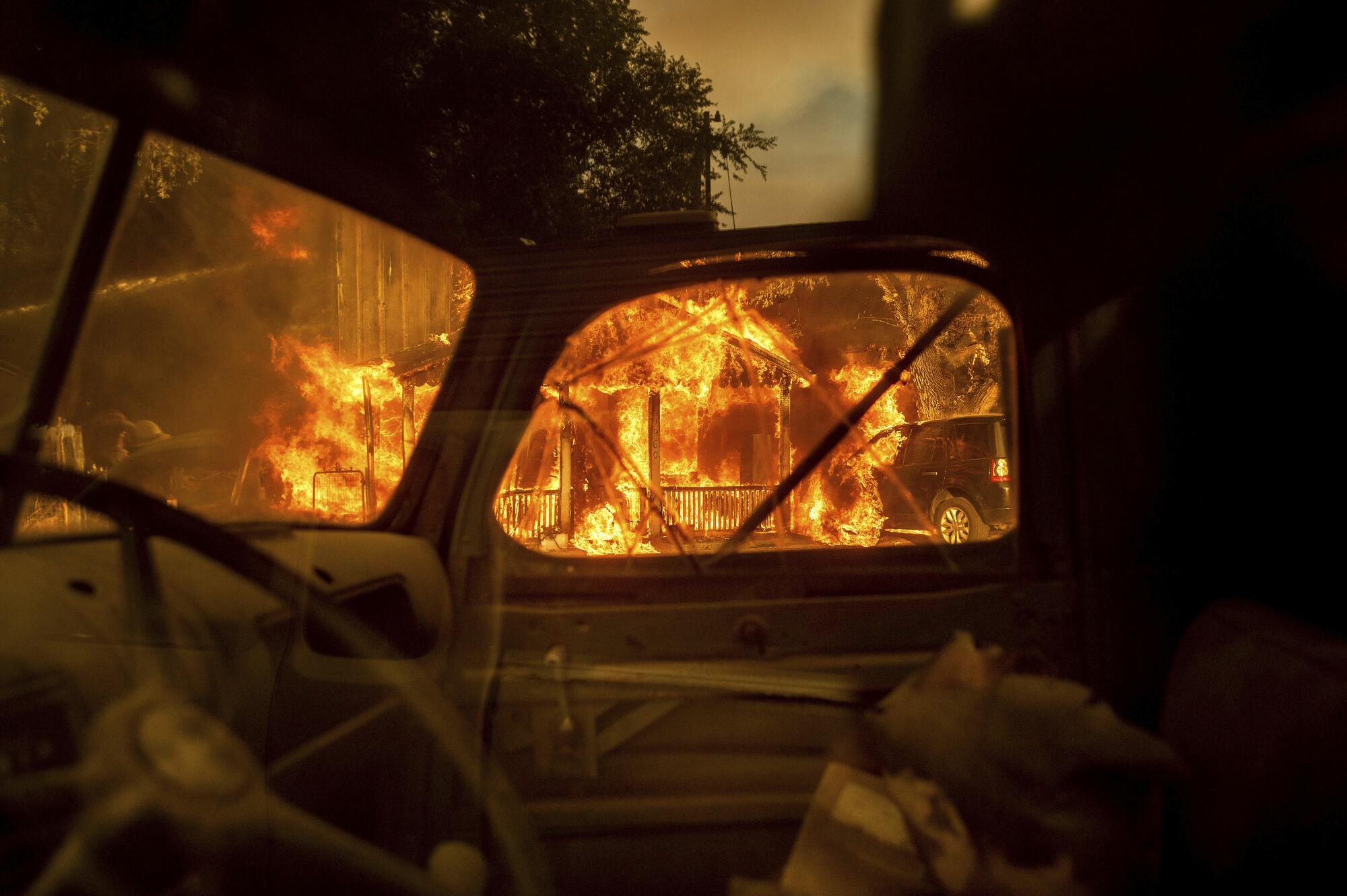 Flames are seen through the window of an automobile.
