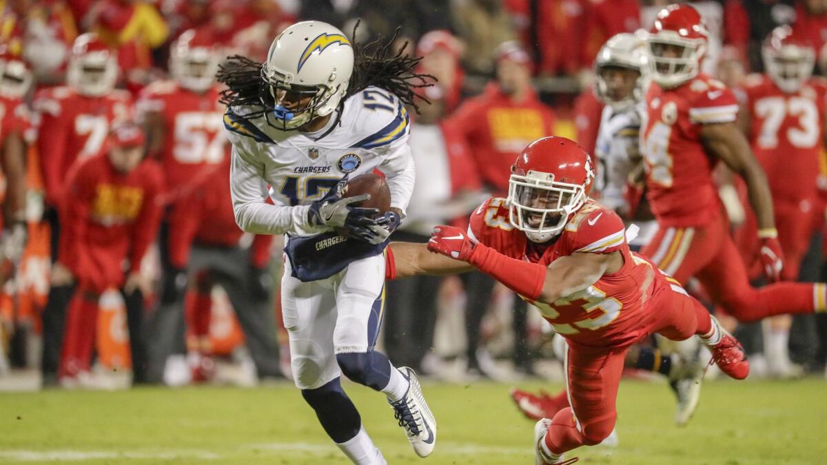 Chargers receiver Travis Benjamin pulls down a pass over Chiefs cornerback Kendall Fuller for 26 yards on a fourth down play to keep the game winning drive alive.