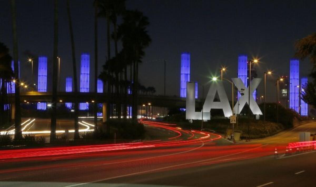 Lighted pylons at the Century Boulevard entrance to Los Angeles International Airport were illuminated in blue Saturday evening in honor of Gerardo Hernandez, the Transportation Security Administration officer slain by a gunman at the airport on Friday.