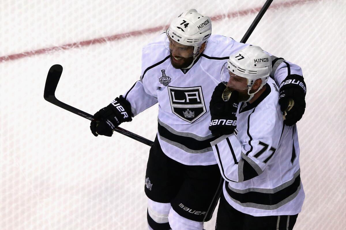 Jeff Carter and Dwight King celebrate a goal on June 9.