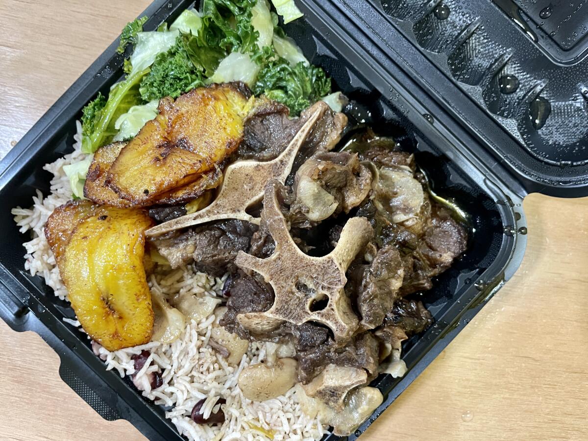 The oxtails lunch with plantains, rice, beans and sauteed kale from Gusina Saraba at Mercado la Paloma in downtown L.A.