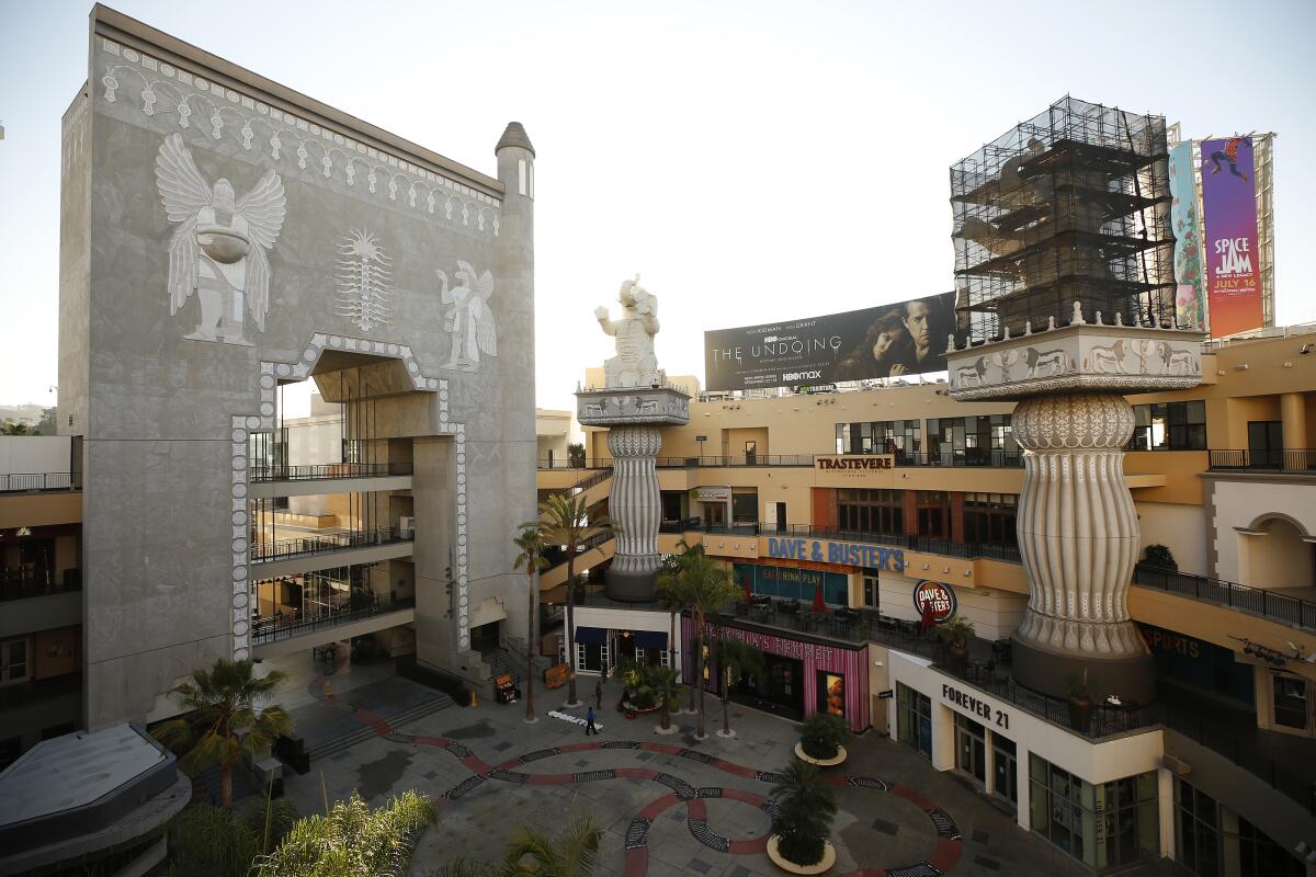 An elevated view shows a faux Babylonian gate and elephants on columns, one of which is covered in scaffolding