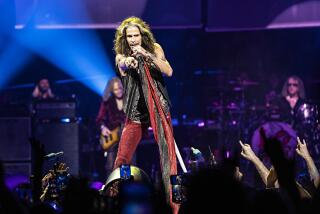 Steven Tyler points toward the audience performs with Aerosmith onstage