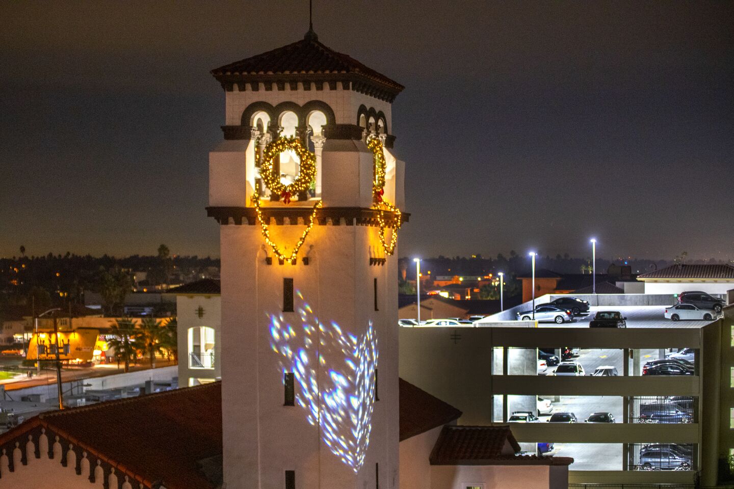The 92-year-old bell tower at First United Methodist Church in Costa Mesa is lighted for the holidays Sunday night. It will be lighted every night through the end of the year.
