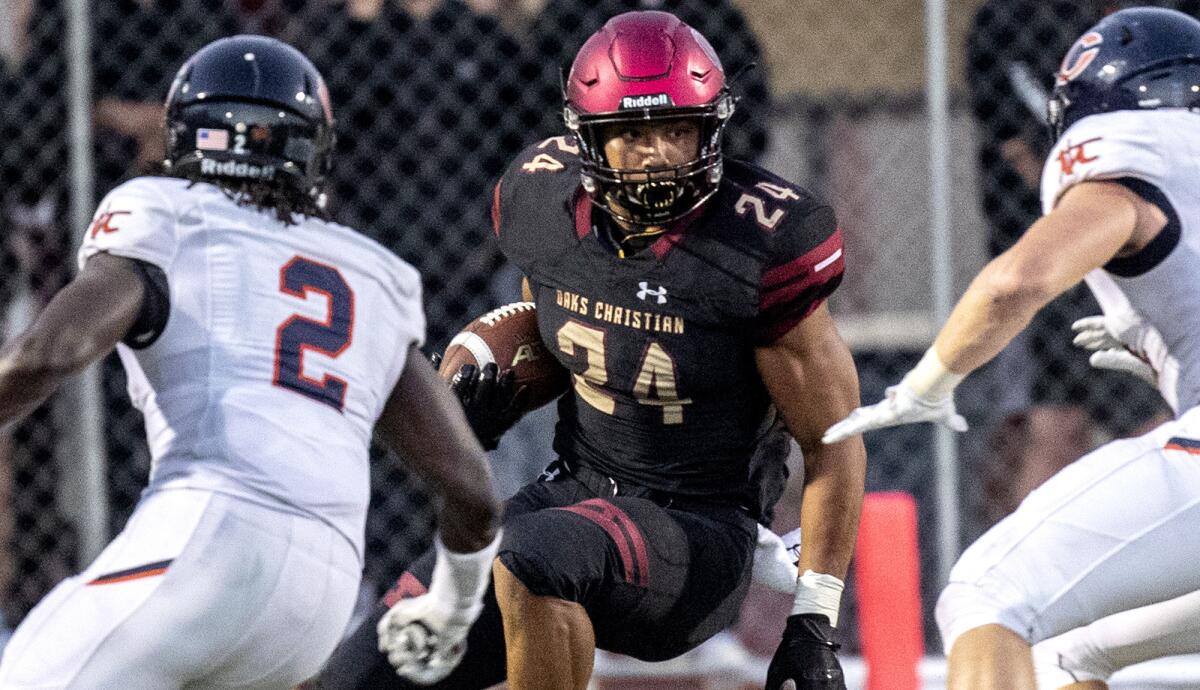 Oaks Christian Zach Charbonnet looks for room to run against Chaminade during a nonleague game earlier this season.