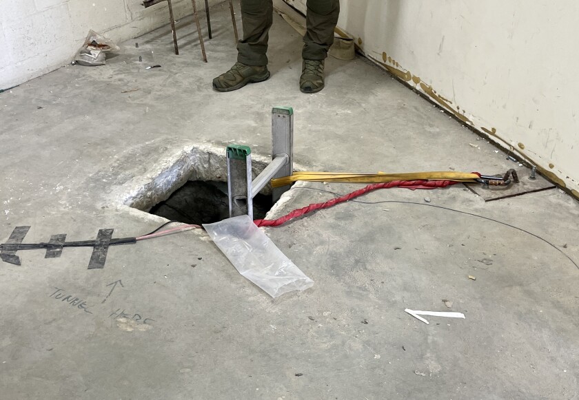 A square in a concrete floor with a ladder poking out