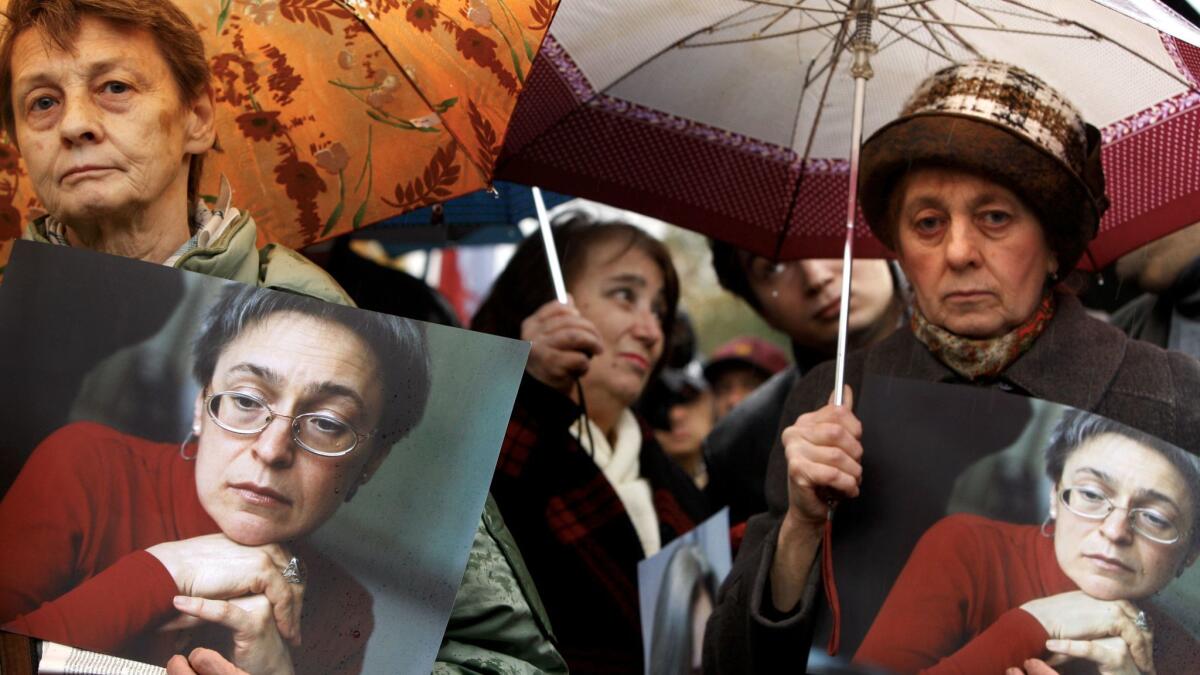 People hold portraits of Anna Politkovskaya during a 2007 rally to mark the first anniversary of the Russian journalist's slaying.