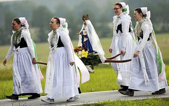 Women in traditional dress carry the statue of the Mother of God during a procession in Rosenthal, Germany. Traditionally on White Monday, the Catholic faithful of the Sorbs, a Slavic minority near the German-Polish border, celebrate an open-air mass in the village about 50 miles east of Dresden.
