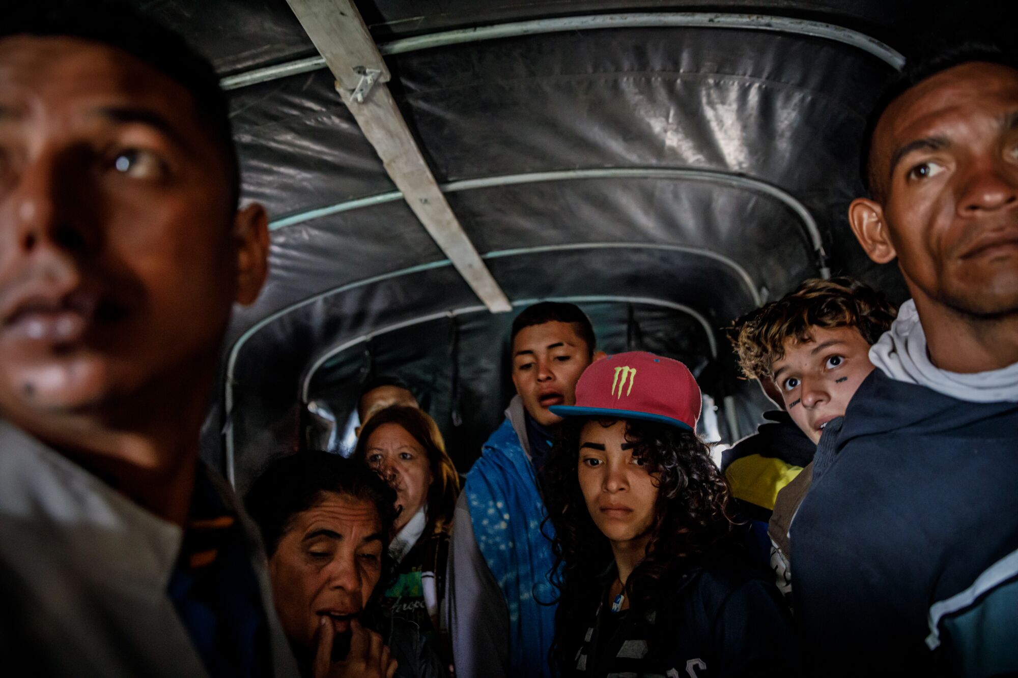 Venezuelan migrants look on as a truck drive closes the tarp to cover the rear to avoid getting caught. The truck is ferrying across the cold plateau, known as El Páramo de Berlín – the most dangerous part of the Andes to get to the other side, towards Bucaramanga, Colombia.