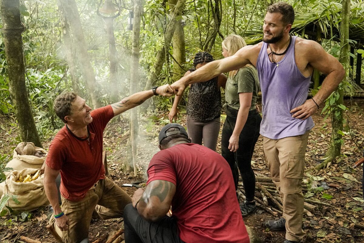 Two men bump fists on the reality program "Beyond the Edge."