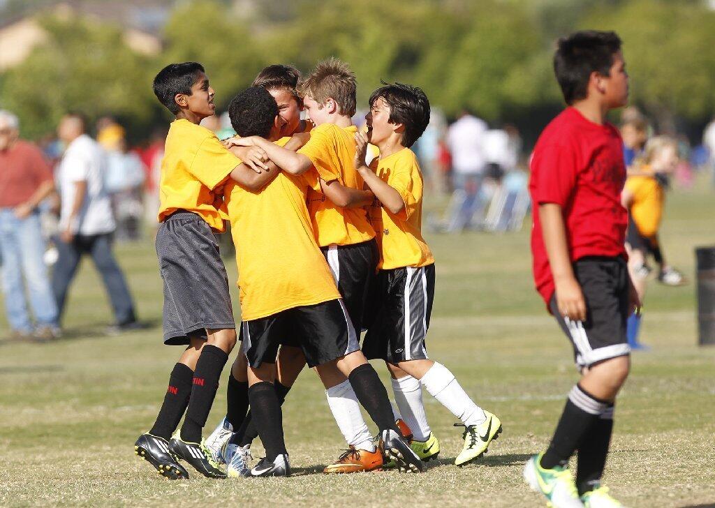 Pegasus players celebrate after a goal against Pomona during a boys' fifth- and sixth-grade gold division game.