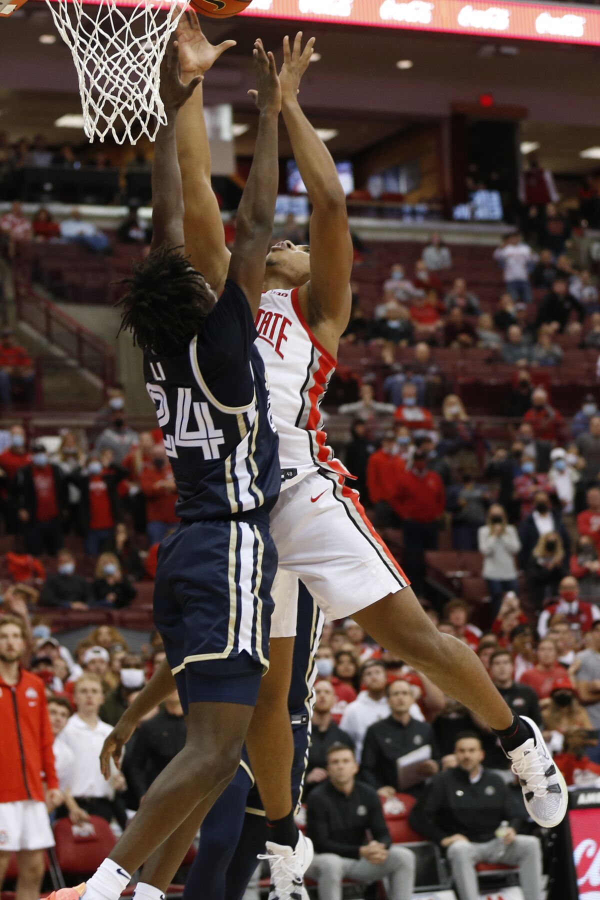 Ohio State's Zed Key, right, makes the game-winning basket over Akron's Ali Ali in the closing second of the second half of an NCAA college basketball game Tuesday, Nov. 9, 2021, in Columbus, Ohio. (AP Photo/Jay LaPrete)