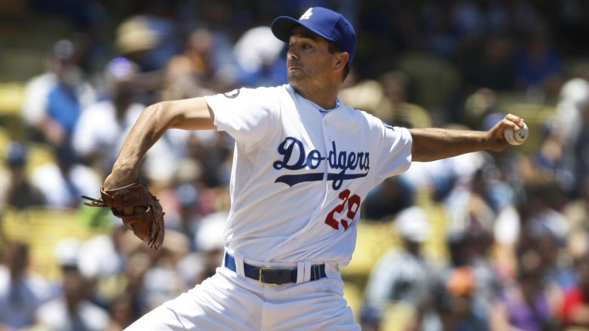 Dodgers pitcher Ted Lilly delivers a pitch during a game against the San Diego Padres in 2011.