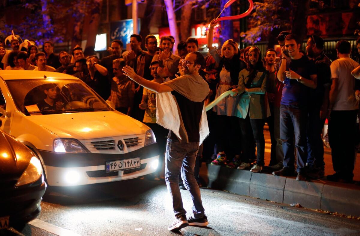 Iranians celebrate in the streets of Tehran on July 14, after nuclear talks between Iran and World powers ended in Vienna, Austria.