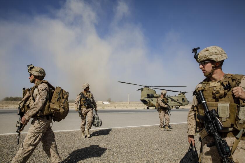CAMP BOST, HELMAND PROVINCE -- SUNDAY, OCTOBER 29, 2017: U.S. Marines disembark from a U.S. Army helicopter at Camp Bost, Helmand Province, on Oct. 29, 2017. About 300 U.S. Marines are deployed in Helmand Province, in southern Afghanistan to train, advice and assist Afghan security forces who are battling the Taliban. The move puts Americans back in a combat role in Helmand province, where Marines fought for more than a decade before they were withdrawn in 2014. (Marcus Yam / Los Angeles Times)